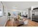 Bright dining area with wood floors and view into living room at 4419 S Xenophon Street, Morrison, CO 80465