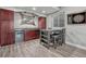 Basement bar featuring wood floors, cabinets, beverage refrigerator, and table with chairs at 600 Coyote Trl, Elizabeth, CO 80107
