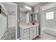This updated bathroom features a spacious vanity, mirror, and a shower tub combo at 600 Coyote Trl, Elizabeth, CO 80107