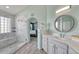 Modern bathroom boasts a tiled shower, updated vanity with a sink, and a view into the bedroom at 600 Coyote Trl, Elizabeth, CO 80107