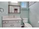 Powder bathroom features a white cabinet, modern mirror and a sink at 600 Coyote Trl, Elizabeth, CO 80107