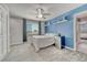 Inviting bedroom with a ceiling fan, window, and a decorative blue accent wall at 600 Coyote Trl, Elizabeth, CO 80107