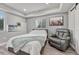 Bedroom with light gray walls, a queen-size bed, a chair, and luxury vinyl plank floors at 600 Coyote Trl, Elizabeth, CO 80107