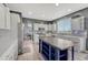 Bright kitchen features an island, stainless steel appliances, grey backsplash, and modern white cabinets at 600 Coyote Trl, Elizabeth, CO 80107