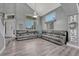 Spacious living room features a large sectional sofa, multiple windows, and modern flooring at 600 Coyote Trl, Elizabeth, CO 80107