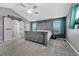 Main bedroom features ceiling fan, carpet floors, grey walls with barn door leading into the bathroom at 600 Coyote Trl, Elizabeth, CO 80107