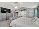 Large primary bedroom with vaulted ceilings, ceiling fan, and barn door to bathroom at 600 Coyote Trl, Elizabeth, CO 80107