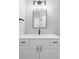 Modern bathroom features a white vanity, sleek black faucet, and vanity lighting at 1541 Glencoe St, Denver, CO 80220