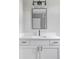 Elegant bathroom vanity with quartz countertop, modern fixtures and framed mirror at 1541 Glencoe St, Denver, CO 80220