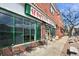 Street view of Spinelli's Market showcasing its brick facade, large display windows, and outdoor seating at 1541 Glencoe St, Denver, CO 80220
