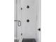 Modern shower features white tiled walls, black fixtures, and a glass door at 1541 Glencoe St, Denver, CO 80220