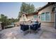 Balcony features a dining area with seating for four overlooking the landscaped yard and pool at 6783 E Orchard Rd, Greenwood Village, CO 80111