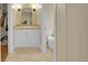 Cozy bathroom featuring a vanity with a stone counter and stylish decor at 6783 E Orchard Rd, Greenwood Village, CO 80111