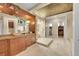 Spacious primary bathroom with a granite counter, a vessel sink, and a frameless glass shower at 6783 E Orchard Rd, Greenwood Village, CO 80111