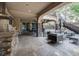 This covered patio has an outdoor kitchen, lounge seating, ceiling fans and a staircase to the second floor at 6783 E Orchard Rd, Greenwood Village, CO 80111
