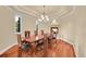 Formal dining room featuring a fireplace, hardwood floors, and ample natural light at 6783 E Orchard Rd, Greenwood Village, CO 80111