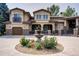 Stucco house exterior with stone accents, covered entryway, and a water fountain at 6783 E Orchard Rd, Greenwood Village, CO 80111
