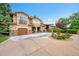 Stunning stucco home with stone accents, a water fountain, and a basketball court at 6783 E Orchard Rd, Greenwood Village, CO 80111