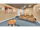 Home theatre with plush seating, carpeted flooring and a projector at 6783 E Orchard Rd, Greenwood Village, CO 80111