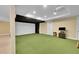 Home theatre area with green carpet, projector and large screen for entertainment at 6783 E Orchard Rd, Greenwood Village, CO 80111
