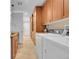 Bright laundry room featuring built-in cabinets, countertops, washer, and dryer at 6783 E Orchard Rd, Greenwood Village, CO 80111