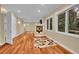 Cozy living room with a fireplace, hardwood floors, and bright windows at 6783 E Orchard Rd, Greenwood Village, CO 80111