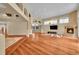 Bright living room with hardwood floors, a fireplace, and multiple windows at 6783 E Orchard Rd, Greenwood Village, CO 80111
