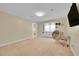 Spacious living room with a cozy chair, and a built-in shelving at 6783 E Orchard Rd, Greenwood Village, CO 80111