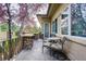 A cozy patio showcases a seating area with an ornate iron railing and well-manicured trees at 6783 E Orchard Rd, Greenwood Village, CO 80111