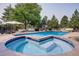 A sparkling in-ground pool and hot tub offer a refreshing oasis surrounded by mature trees and landscaping at 6783 E Orchard Rd, Greenwood Village, CO 80111