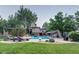 Backyard oasis features an in-ground pool, slide, lounge chairs and lush landscaping at 6783 E Orchard Rd, Greenwood Village, CO 80111