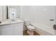 Clean and bright bathroom featuring a modern vanity with a single sink and a tiled tub-shower combination at 1242 Penner Dr, Erie, CO 80026