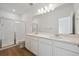 Bright bathroom featuring double vanity sinks, a large mirror, and a modern glass-enclosed shower at 1242 Penner Dr, Erie, CO 80026