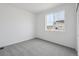 Bright, simple bedroom with a large window and neutral carpet at 1242 Penner Dr, Erie, CO 80026