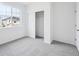 Neutral bedroom featuring a closet, large window and neutral-toned carpet at 1242 Penner Dr, Erie, CO 80026