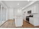 Modern kitchen with sleek white cabinets, stainless steel appliances, and island with sink at 1242 Penner Dr, Erie, CO 80026