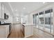 Modern open kitchen featuring an island, stainless appliances, and access to the patio at 1242 Penner Dr, Erie, CO 80026