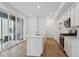 Bright kitchen featuring stainless steel appliances, white cabinetry, and a center island at 1242 Penner Dr, Erie, CO 80026