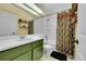 Bright bathroom features patterned shower curtain, a single sink, and tile flooring at 18273 E Arizona Ave # D, Aurora, CO 80017