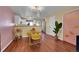 Modern dining area with a glass table, yellow chairs, and stylish accents at 18273 E Arizona Ave # D, Aurora, CO 80017