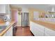 Open kitchen with a stainless steel refrigerator and butcher block counters at 18273 E Arizona Ave # D, Aurora, CO 80017