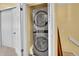 A stacked washer and dryer unit sits inside of a narrow closet at 18273 E Arizona Ave # D, Aurora, CO 80017