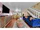 Bright living room featuring hardwood floors, staircase, and contemporary furnishings at 18273 E Arizona Ave # D, Aurora, CO 80017