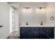 Bathroom showcasing dual sinks, shaker cabinets, quartz counters, and modern light fixtures at 5424 Freddys Trl, Parker, CO 80134
