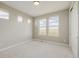 Bright bedroom featuring neutral tones, plush carpet, and a trio of windows offering scenic views at 5424 Freddys Trl, Parker, CO 80134