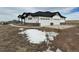 Exterior view of a modern home with a two-car garage and newly poured driveway at 5424 Freddys Trl, Parker, CO 80134