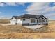 Beautiful single-story home with white siding, black trim, and large windows on a spacious lot at 5424 Freddys Trl, Parker, CO 80134