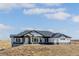 Stunning single-story home with white siding, dark trim, and a stone foundation on a large lot at 5424 Freddys Trl, Parker, CO 80134