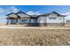 Beautiful ranch style home featuring white siding, dark trim, stone accents, and a covered front porch at 5424 Freddys Trl, Parker, CO 80134