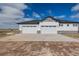 A three car garage with white doors and stone facade on a sunny day at 5424 Freddys Trl, Parker, CO 80134
